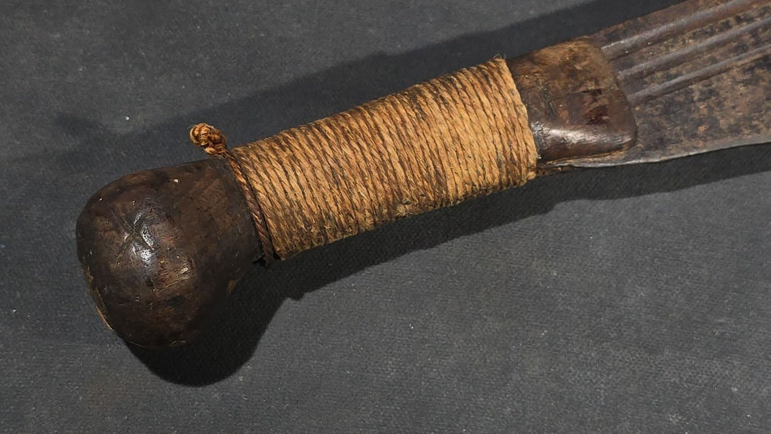 antique Machete with Curved Blade, Cord-Wrapped Handle, and Rounded Pommel