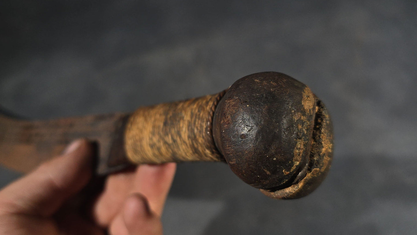 antique Machete with Curved Blade, Cord-Wrapped Handle, and Rounded Pommel