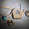 Lot 128 - Vintage Copper Tibetan Ghau Prayer Box with Repousse Deity Figure, Cloisonne Enamel Bead, and Leather Cord with Two Small Leather Pouches
