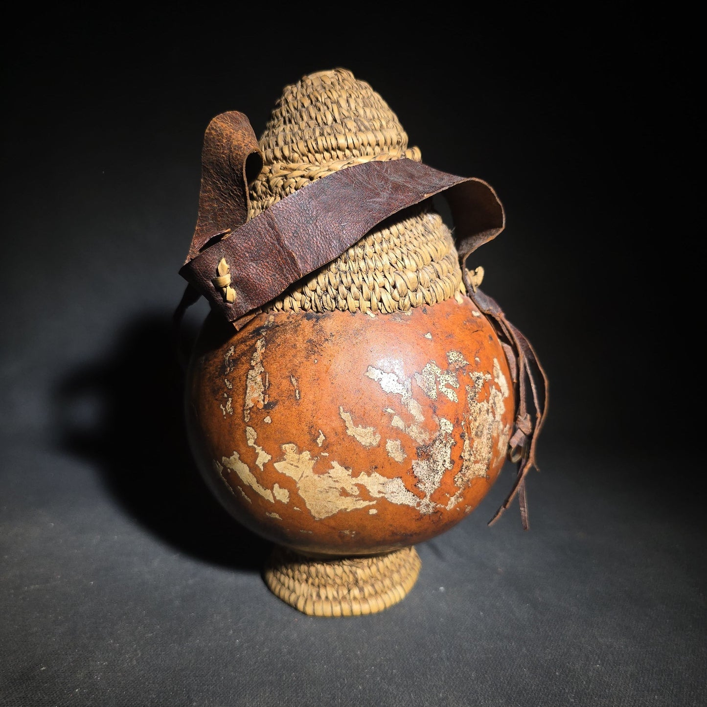 Pair of Vintage Woven Baskets including a Gourd Vessel with Leather Strap and Woven Stopper and a Coiled Lidded Basket