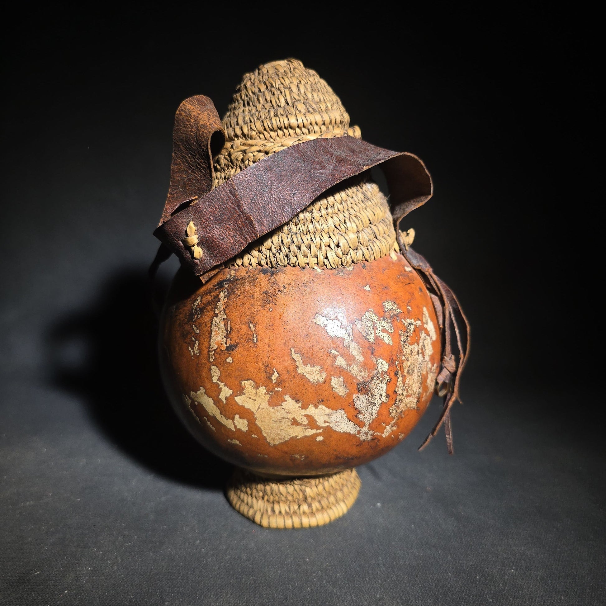 Pair of Vintage Woven Baskets including a Gourd Vessel with Leather Strap and Woven Stopper and a Coiled Lidded Basket