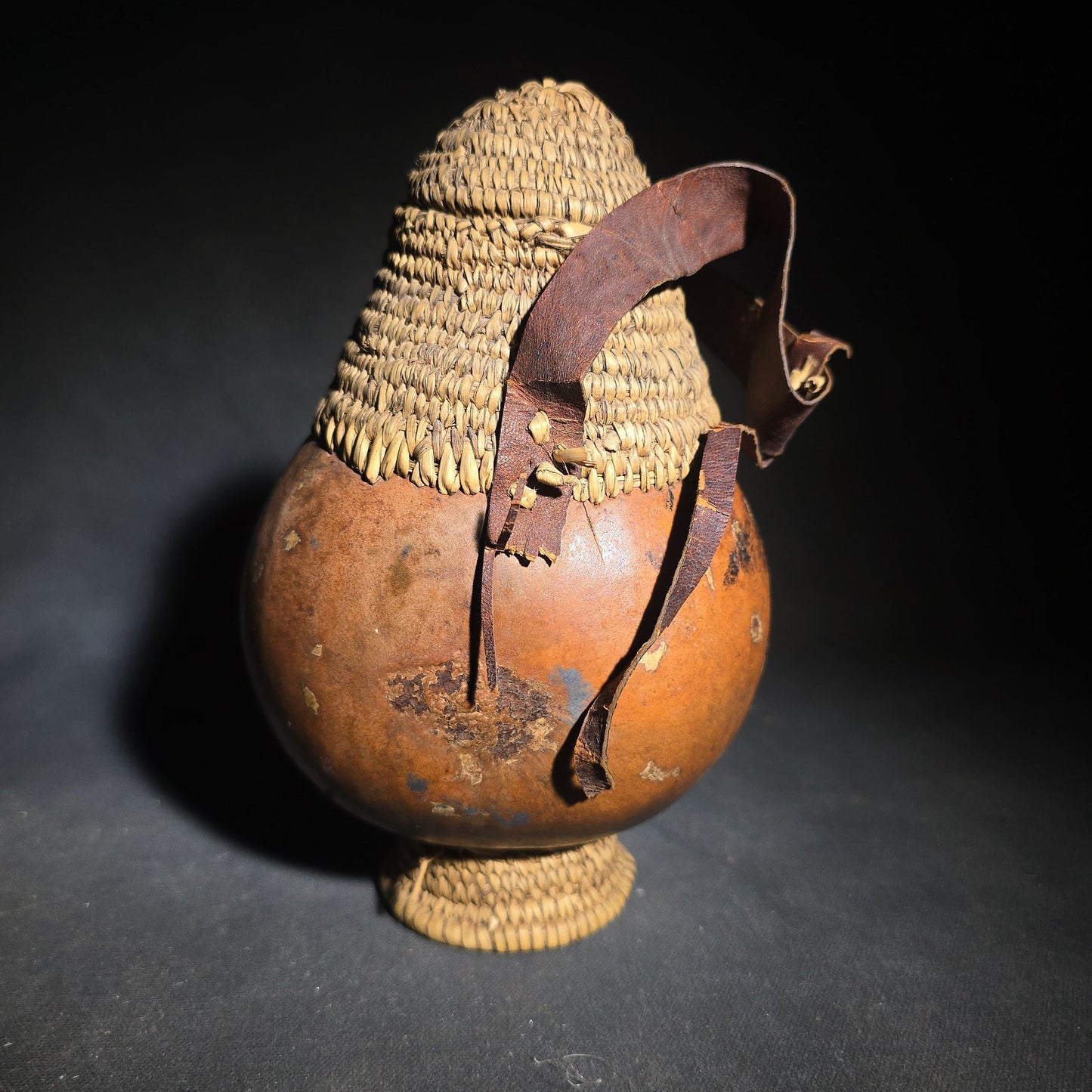 Pair of Vintage Woven Baskets including a Gourd Vessel with Leather Strap and Woven Stopper and a Coiled Lidded Basket