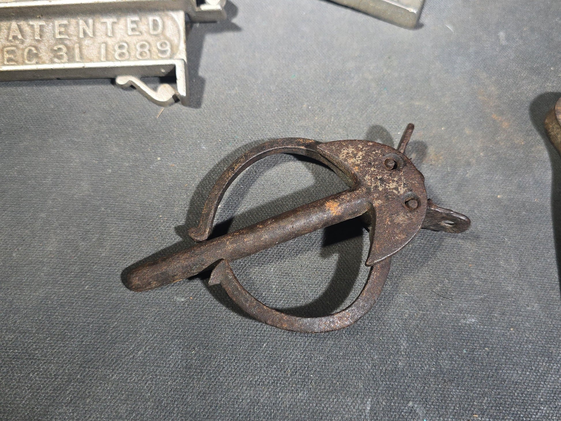 Grouping of Seven Antique Iron Hardware Pieces including Four R.S. Jewett Ornate Shelf Brackets Patented December 31, 1889, a Swivel Ring, and Two Cotter Pins