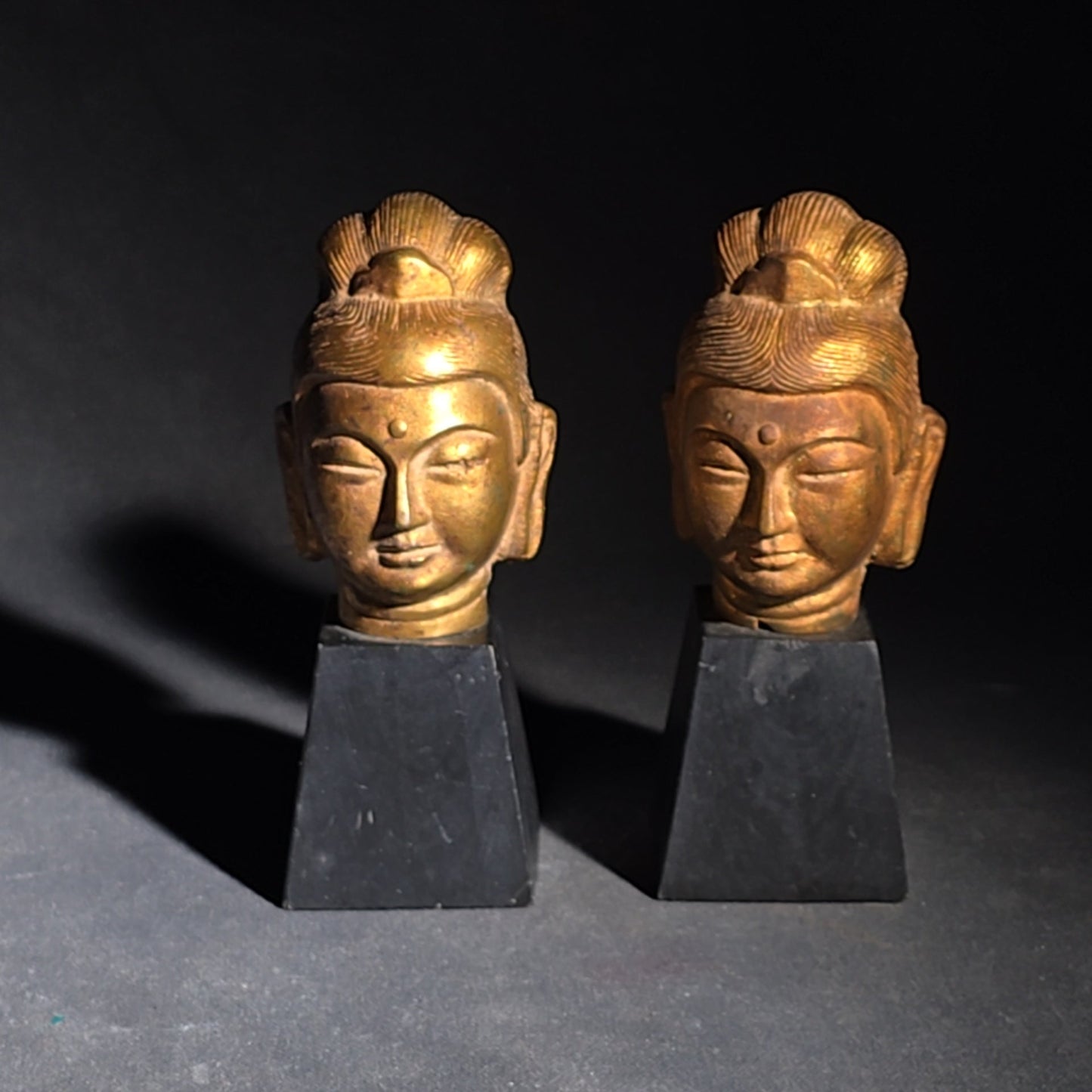 Grouping of Four Vintage Brass Pieces including Pair of Gilt Bodhisattva Head Busts on Stands and Pair of Korean Folding Bookends with Pagoda Gate Design
