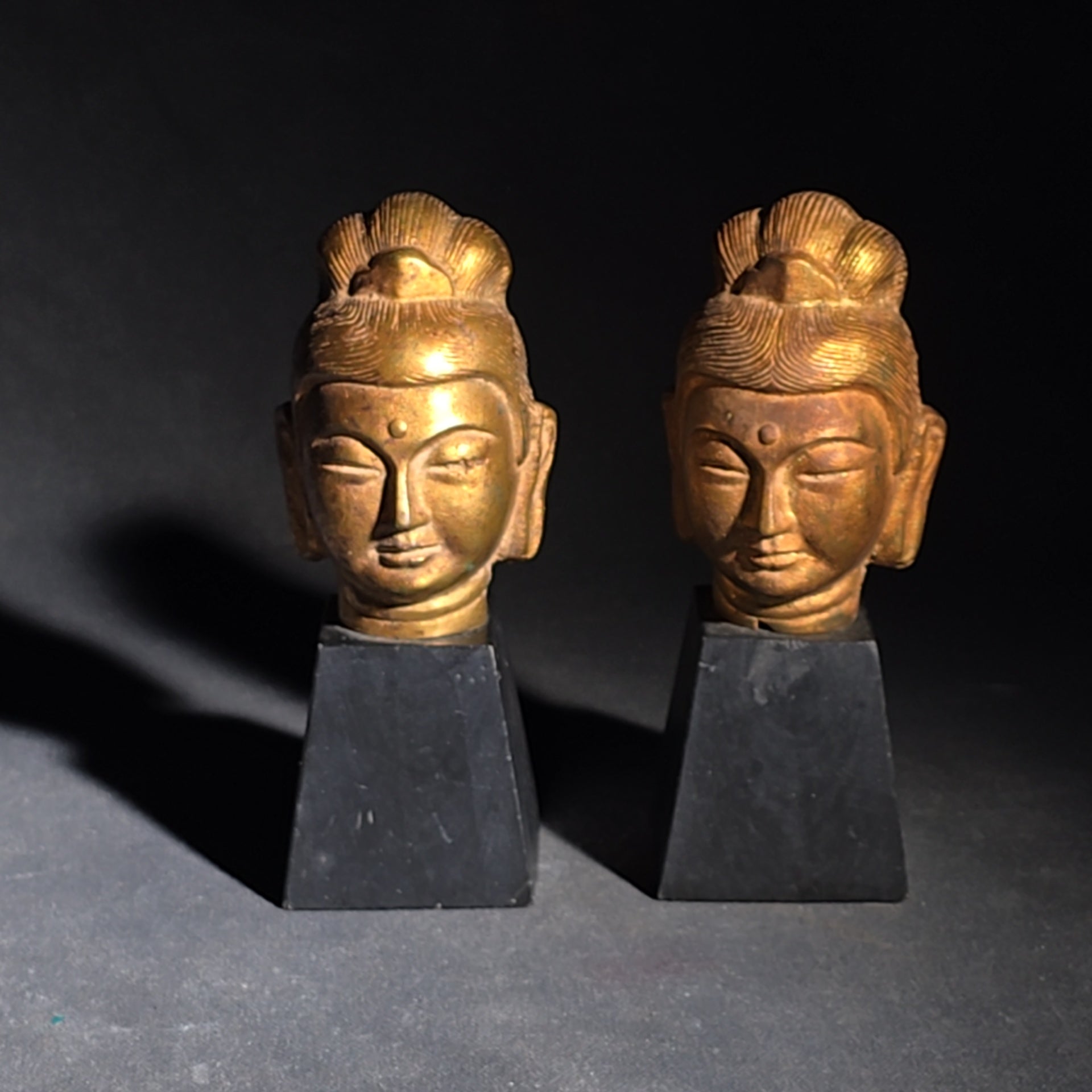 Grouping of Four Vintage Brass Pieces including Pair of Gilt Bodhisattva Head Busts on Stands and Pair of Korean Folding Bookends with Pagoda Gate Design