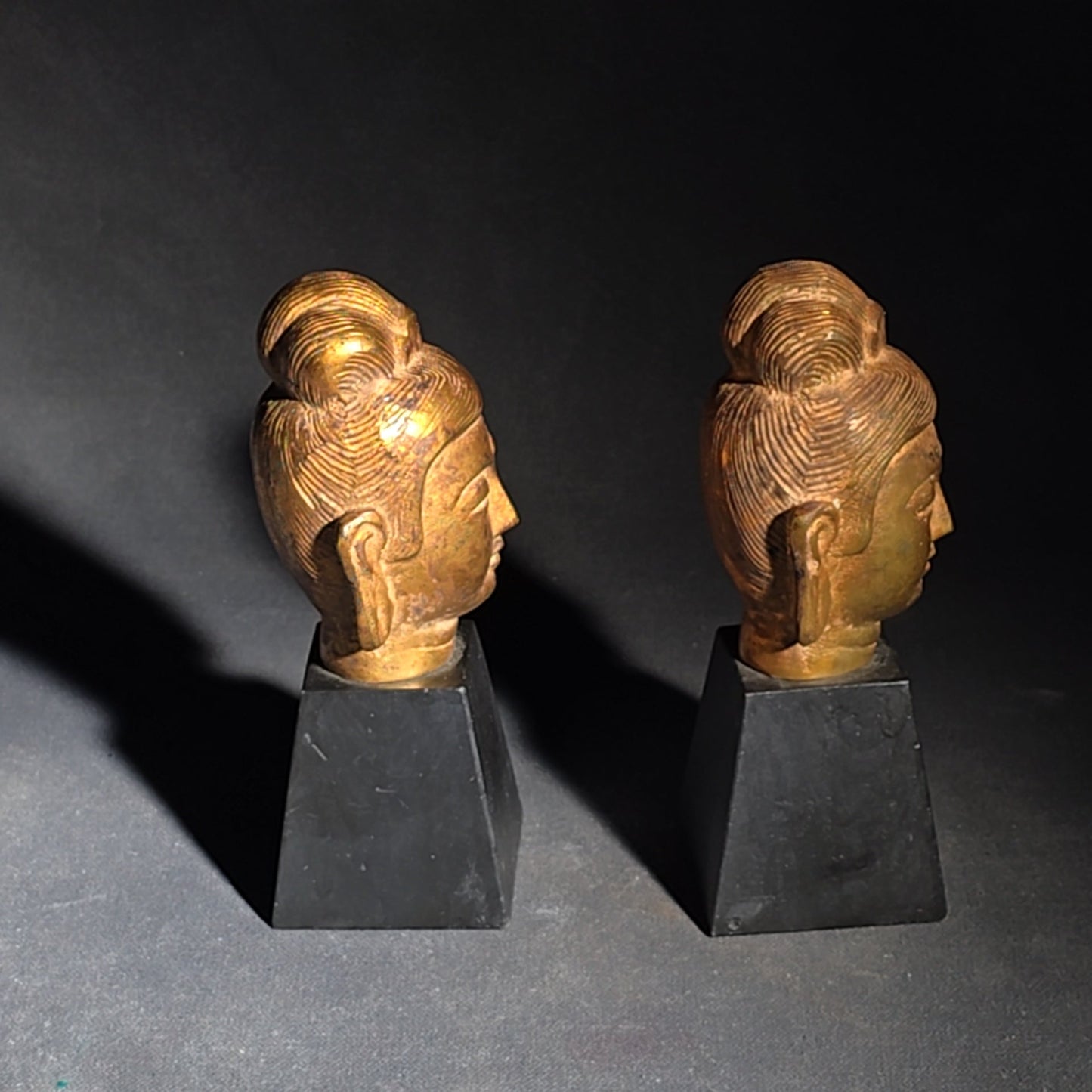 Grouping of Four Vintage Brass Pieces including Pair of Gilt Bodhisattva Head Busts on Stands and Pair of Korean Folding Bookends with Pagoda Gate Design