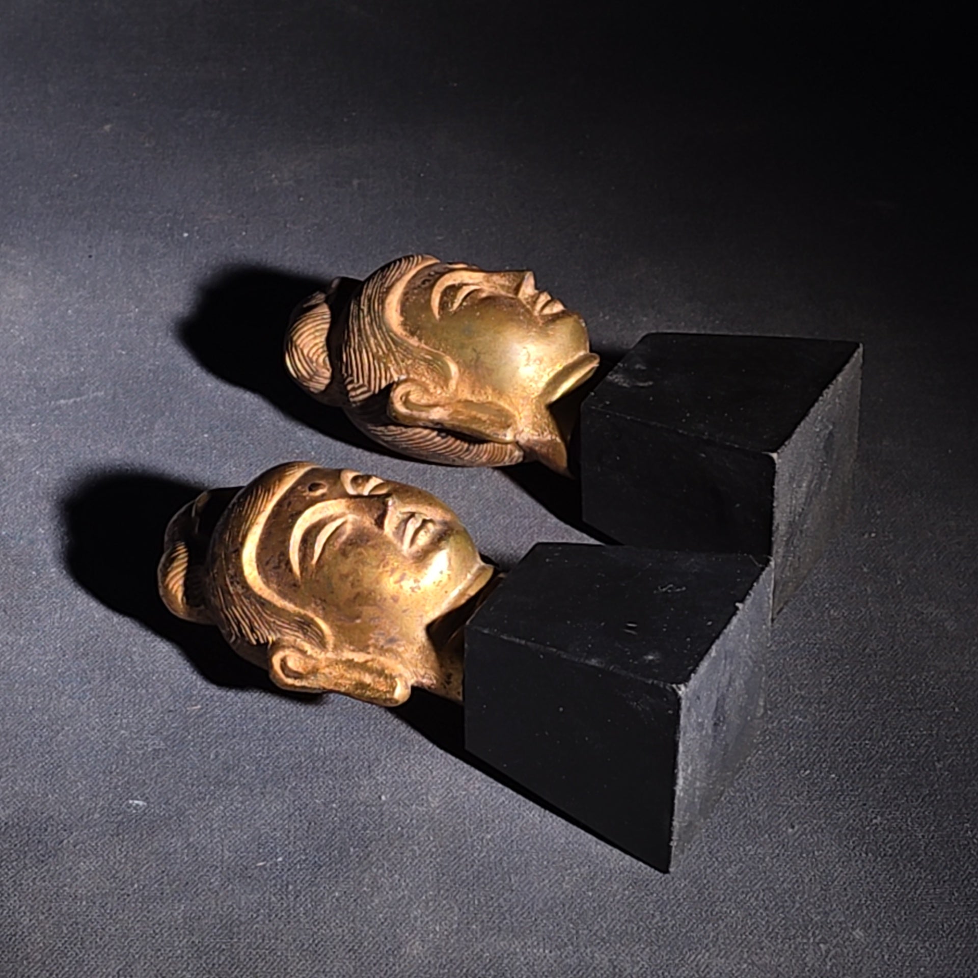 Grouping of Four Vintage Brass Pieces including Pair of Gilt Bodhisattva Head Busts on Stands and Pair of Korean Folding Bookends with Pagoda Gate Design