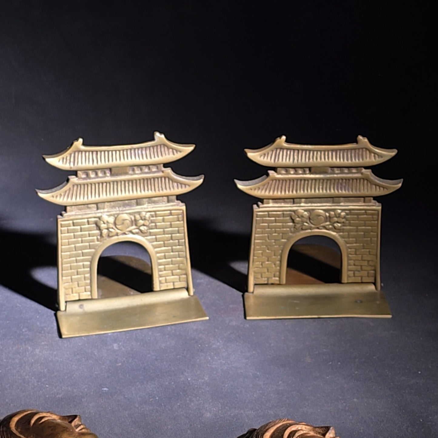 Grouping of Four Vintage Brass Pieces including Pair of Gilt Bodhisattva Head Busts on Stands and Pair of Korean Folding Bookends with Pagoda Gate Design