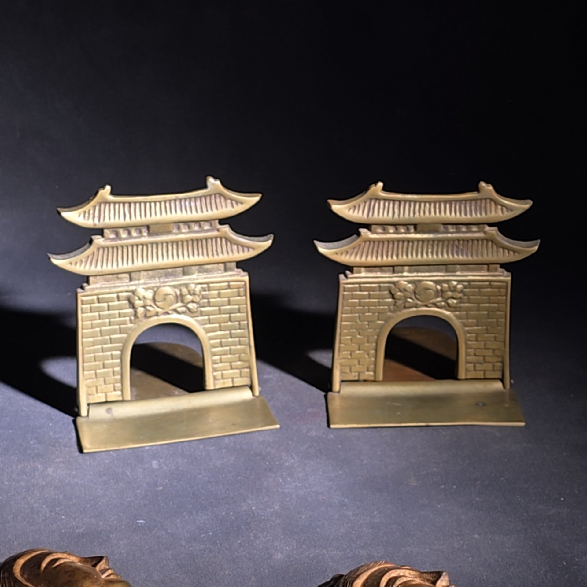 Grouping of Four Vintage Brass Pieces including Pair of Gilt Bodhisattva Head Busts on Stands and Pair of Korean Folding Bookends with Pagoda Gate Design