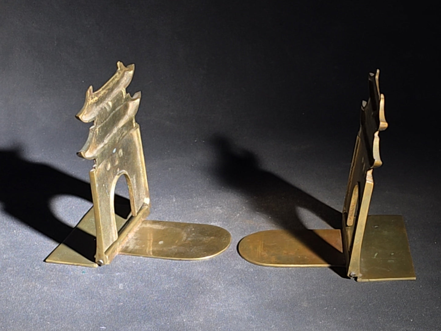 Grouping of Four Vintage Brass Pieces including Pair of Gilt Bodhisattva Head Busts on Stands and Pair of Korean Folding Bookends with Pagoda Gate Design