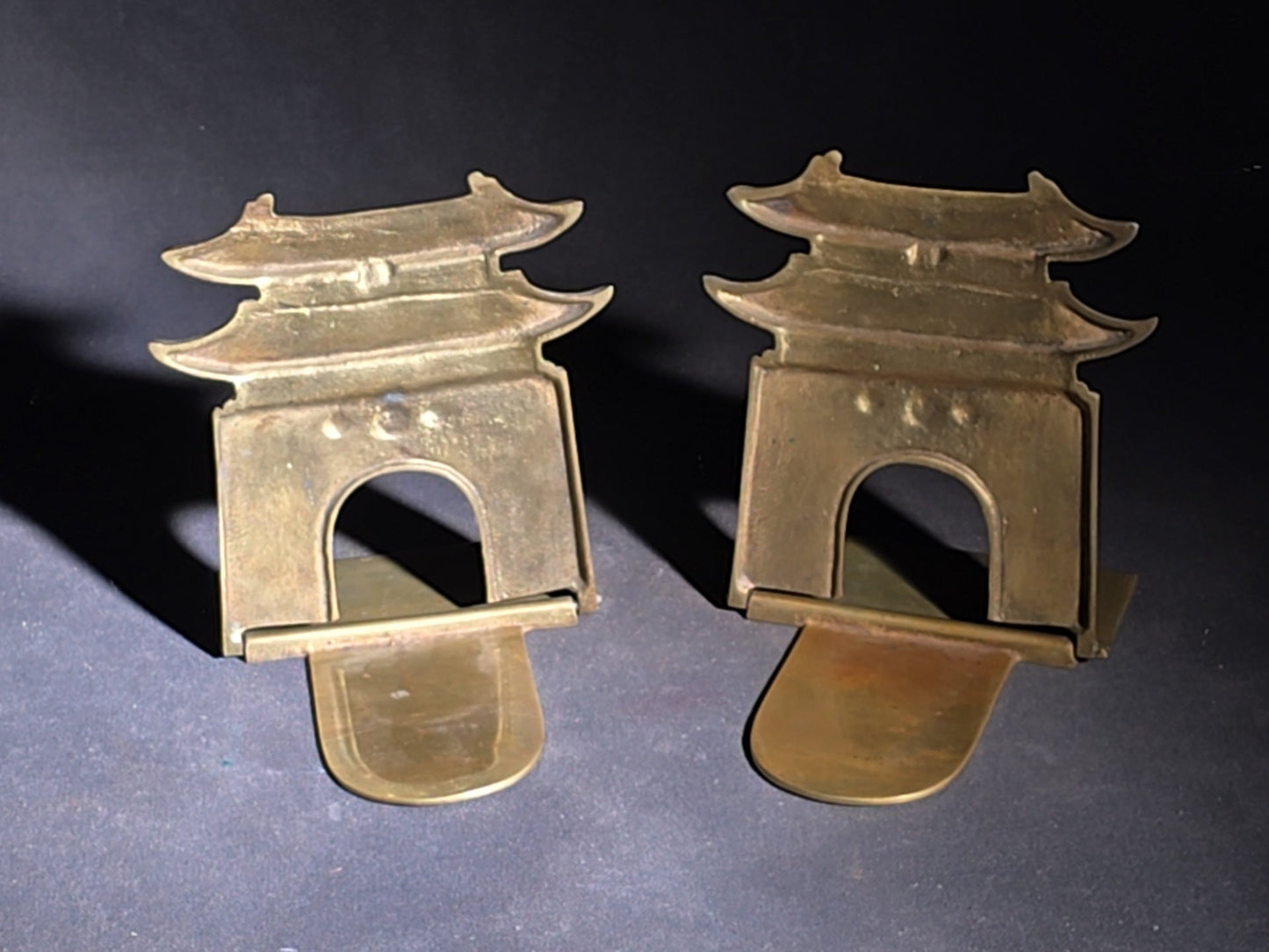 Grouping of Four Vintage Brass Pieces including Pair of Gilt Bodhisattva Head Busts on Stands and Pair of Korean Folding Bookends with Pagoda Gate Design