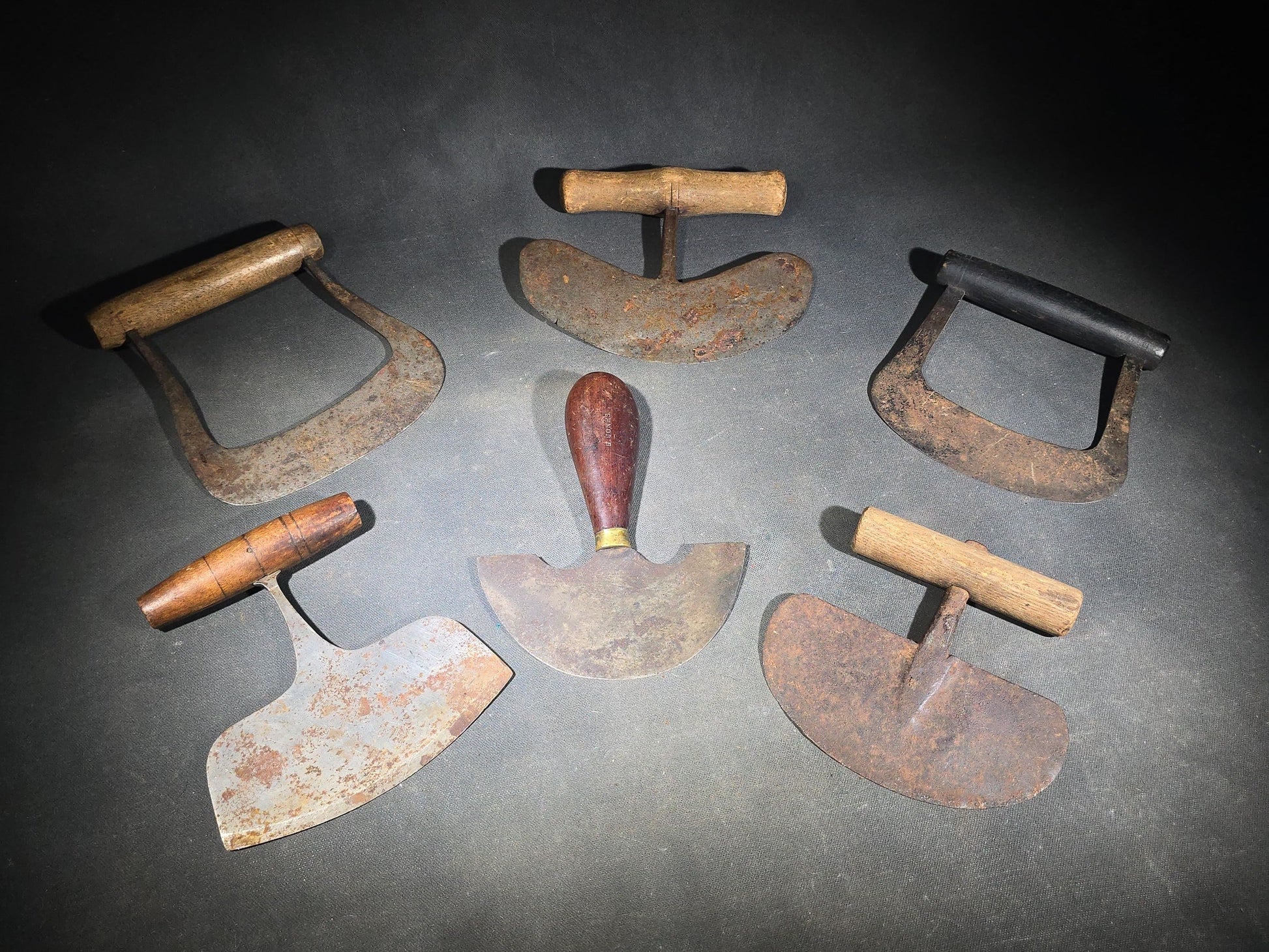 Grouping of Six Antique Iron Food Choppers with Wood Handles including One Stamped S. Jones