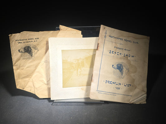 Grouping of Three Antique Westminster Kennel Club Dog Ephemera Pieces including 1895 Nineteenth Annual Bench Show Premium List with Spratts Patent Advertising, Illustrated Mailing Envelope, and Board-Mounted Photograph of a Child with a Dog