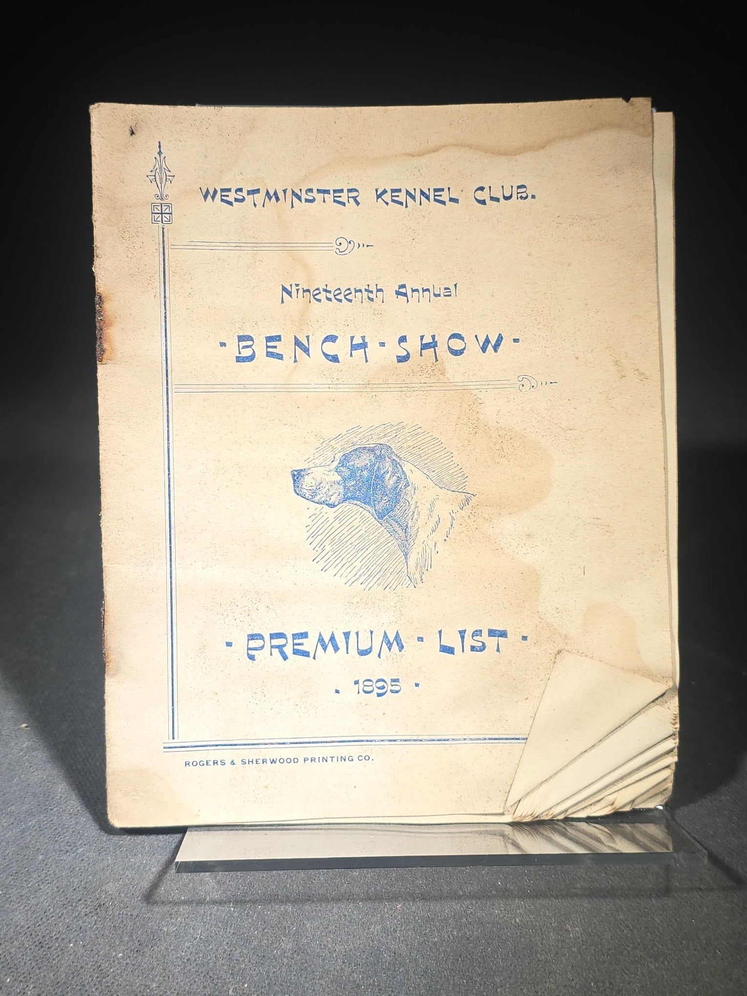 Grouping of Three Antique Westminster Kennel Club Dog Ephemera Pieces including 1895 Nineteenth Annual Bench Show Premium List with Spratts Patent Advertising, Illustrated Mailing Envelope, and Board-Mounted Photograph of a Child with a Dog