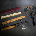 Lot 139 - Grouping of Four Antique and Vintage Tools Including Swordfish Brand Multi-Tool Hatchet, Frederick Post Co. Slide Rule with Case, Advertising Wooden Ruler, and Cast Iron Measuring Wheel