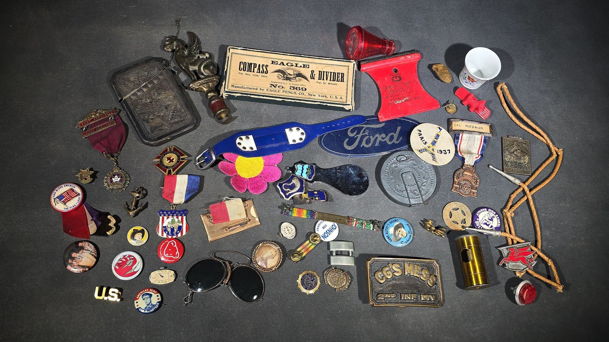 Grouping of Antique and Vintage Junk Drawer Smalls including Eagle Pencil Co. Compass Box, Ford Key Fob, Military Medals and Belt Buckle, Eyeglasses, Match Safe, and Pinback Buttons