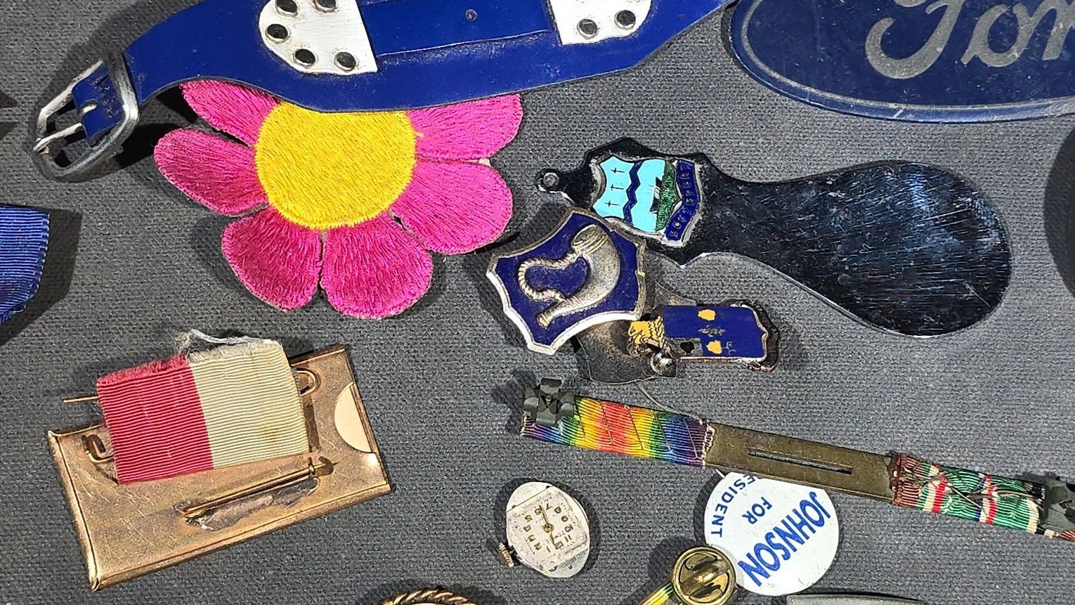Grouping of Antique and Vintage Junk Drawer Smalls including Eagle Pencil Co. Compass Box, Ford Key Fob, Military Medals and Belt Buckle, Eyeglasses, Match Safe, and Pinback Buttons