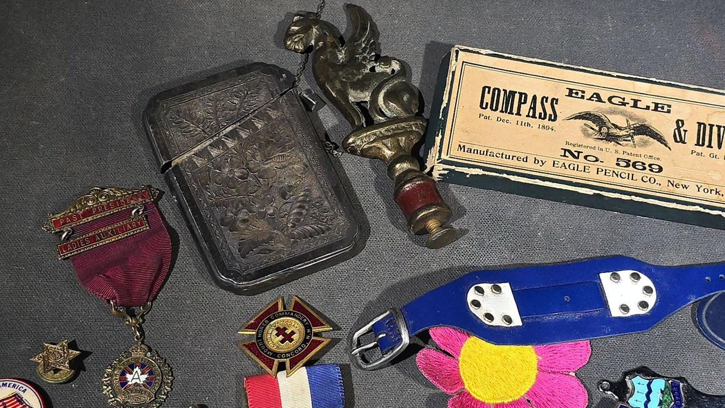 Grouping of Antique and Vintage Junk Drawer Smalls including Eagle Pencil Co. Compass Box, Ford Key Fob, Military Medals and Belt Buckle, Eyeglasses, Match Safe, and Pinback Buttons