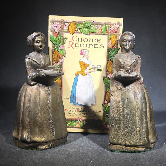 Pair of Antique Cast Iron Advertising Bookends and "Choice Recipes" Booklet, Walter Baker & Co. Ltd., Dorchester, Massachusetts, "La Belle Chocolatiere" Chocolate Maid Figure