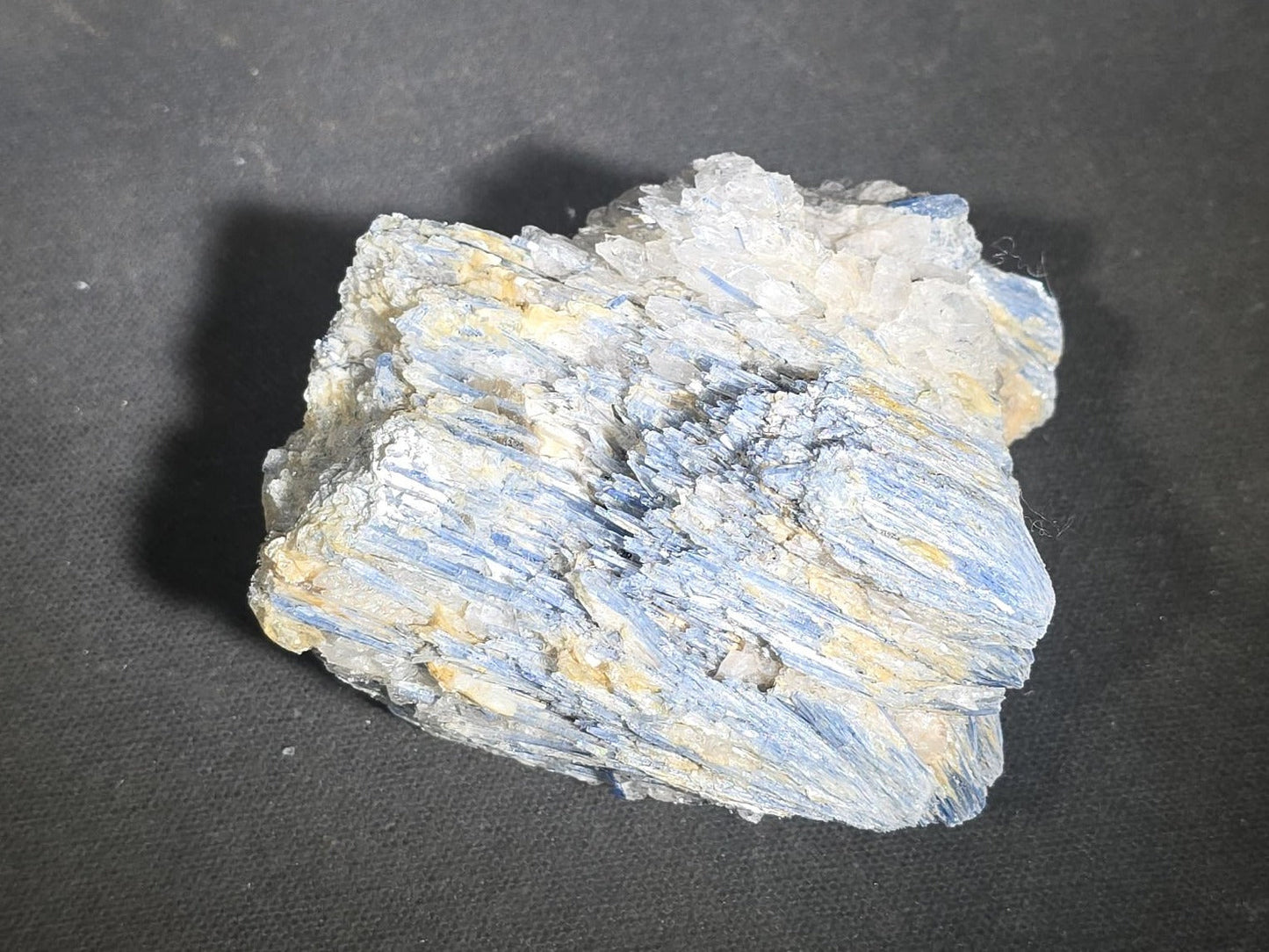 Grouping of Five Mineral Specimens Including Four Quartz Crystal Points and Blue Kyanite in Matrix