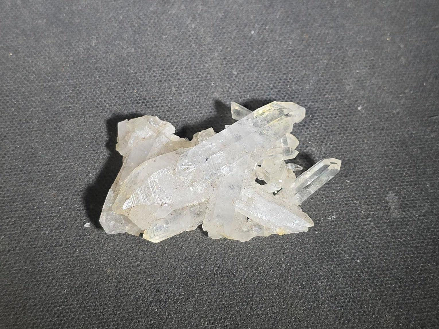 Grouping of Five Mineral Specimens Including Four Quartz Crystal Points and Blue Kyanite in Matrix