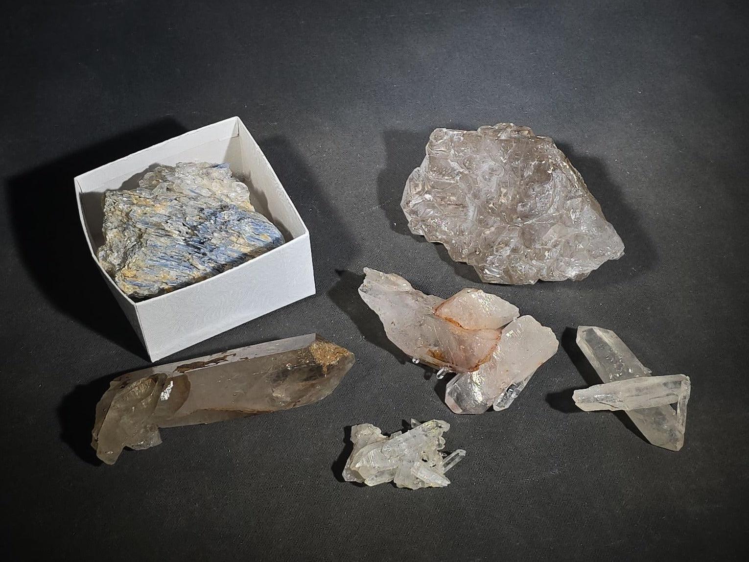 Grouping of Five Mineral Specimens Including Four Quartz Crystal Points and Blue Kyanite in Matrix