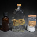 Lot 145 - Trio of Vintage Glass Bottles and Jars Including "Ancient Bottle" Whiskey by Distillers Corporation Limited of Canada and Powdered French Chalk Jar from Harry C. Zeisig Drugstore