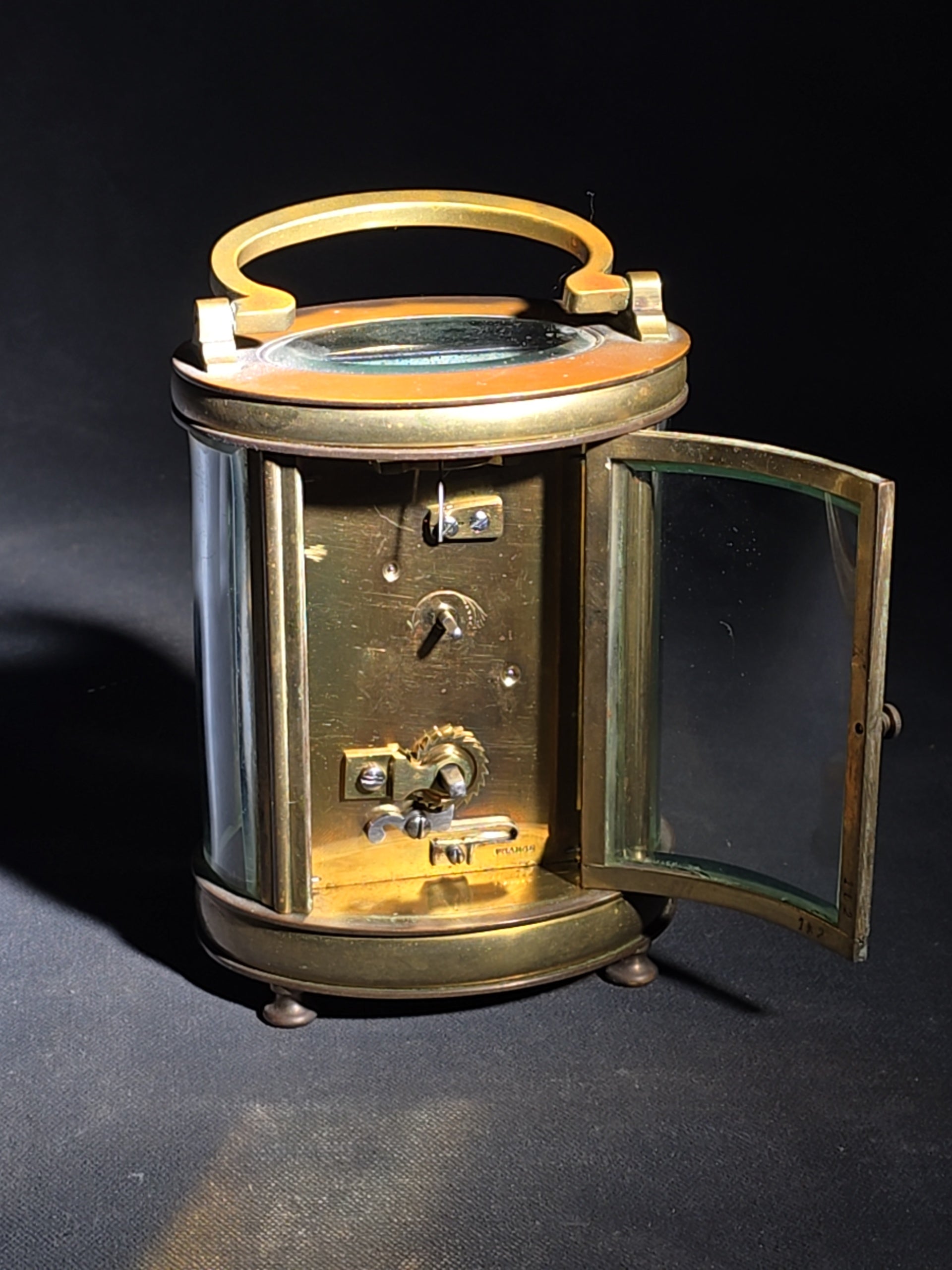 Antique French Brass Oval Carriage Clock with Five Beveled Glass Panels and Roman Numeral Dial, France, Chipped