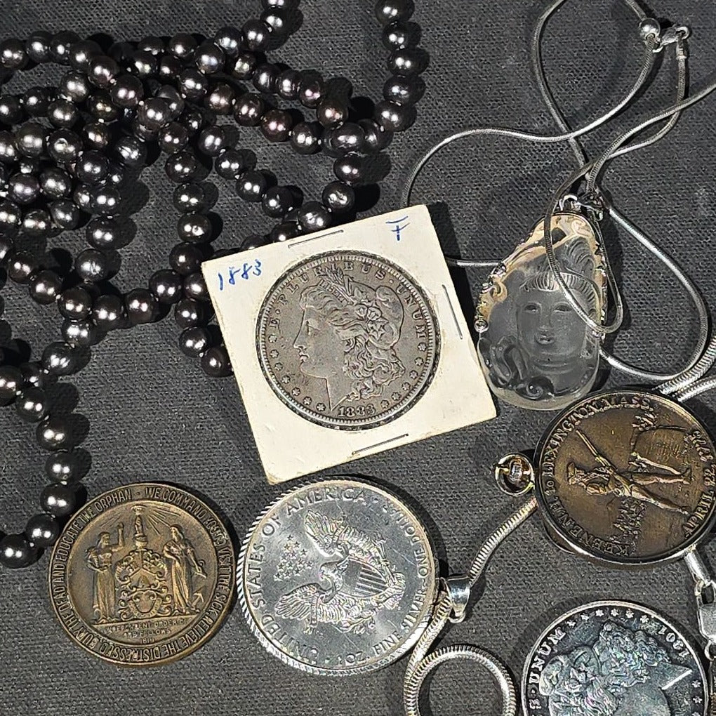 Lot 148 - Grouping of Antique and Reproduction Coins, Coin Pendants, Bead Necklaces, and Carved Pendant Including 1883 Morgan Dollar and Seated Liberty Coin Jewelry (12)