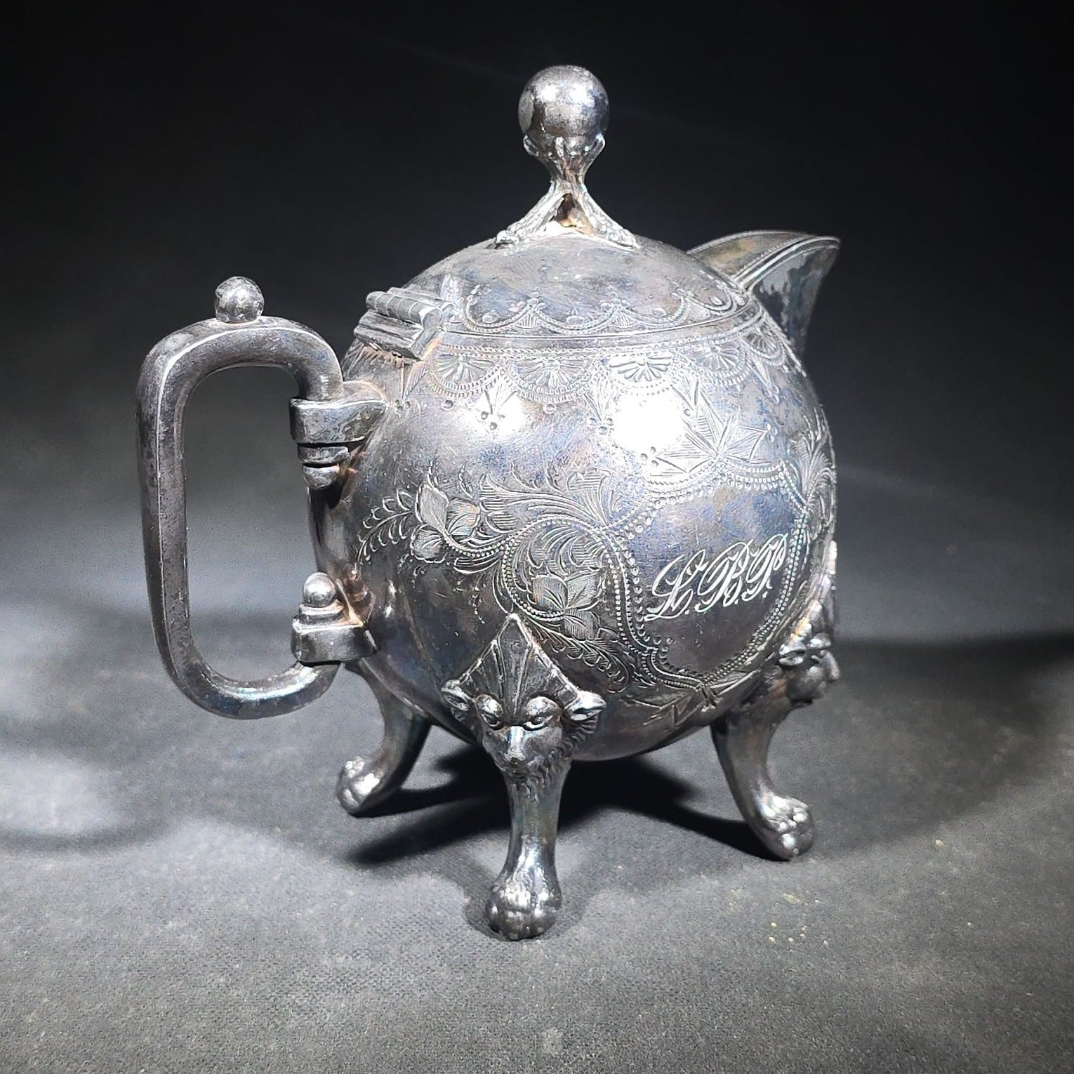 Pair of Antique Silverplate Serving Pieces including Reed & Barton Footed Coffeepot No. 2930 and Monogrammed Spherical Teapot with Lion Mask and Paw Feet