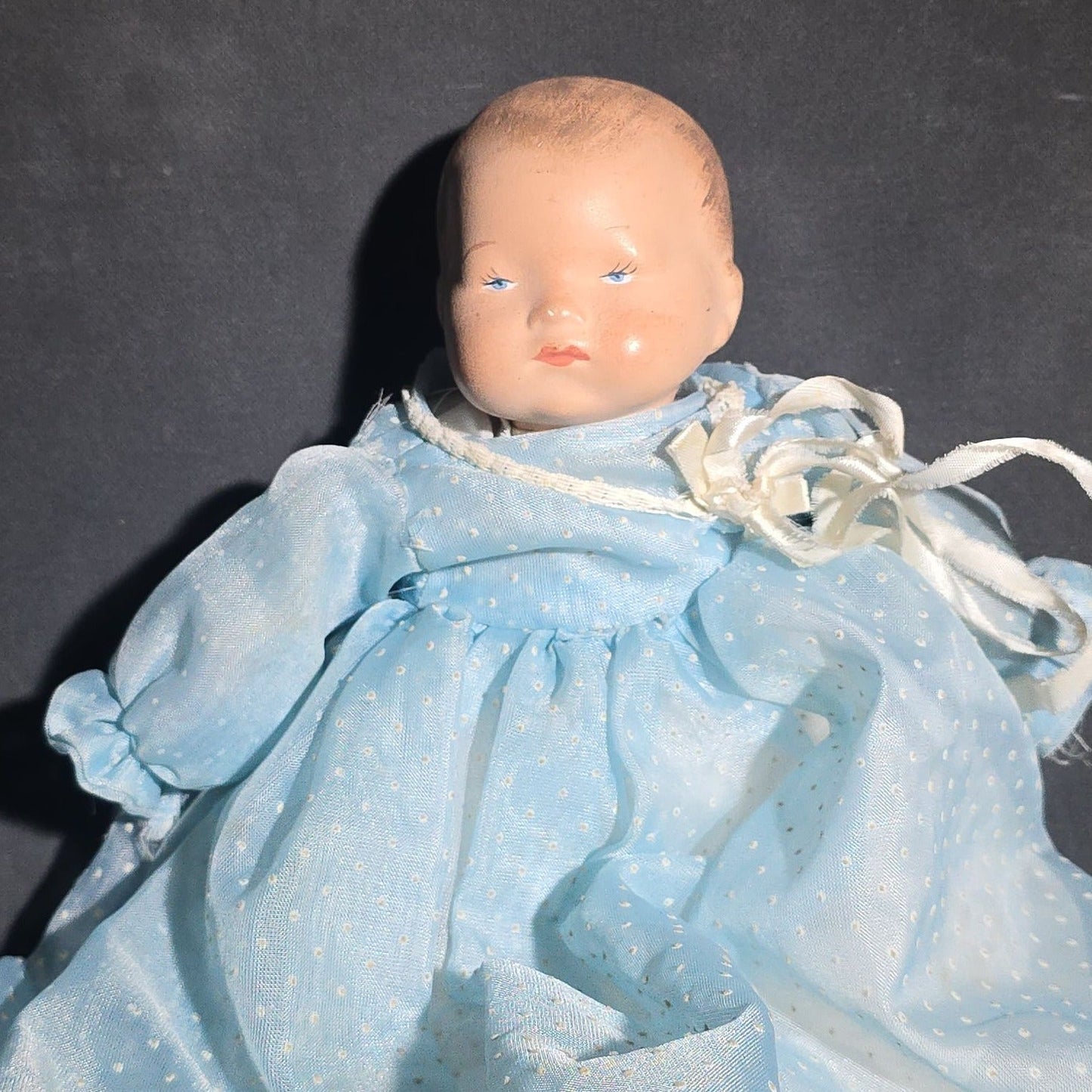 Modern Baby Doll in Blue Polka Dot Christening Gown with Painted Features and White Ribbon Bow