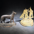Lot 095 - Pair of Antique Mismatched Cast Iron Bookends Including a Standing Dog and a Sailing Ship, Manufactured by Bradley & Hubbard Mfg. Co., Meriden, Connecticut