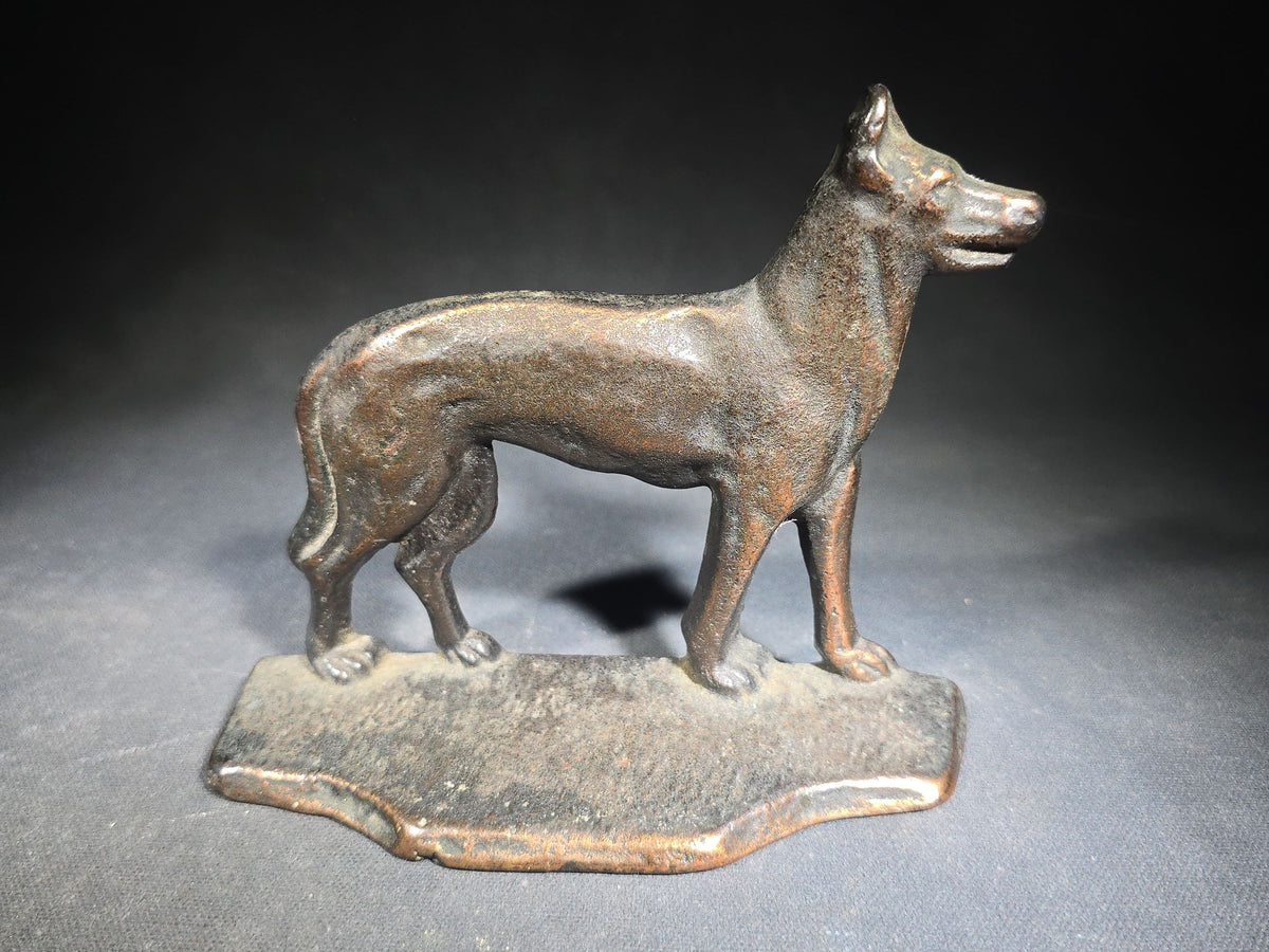 Pair of Antique Mismatched Cast Iron Bookends including a Standing Dog and a Sailing Ship, Manufactured by Bradley & Hubbard Mfg. Co., Meriden, Connecticut