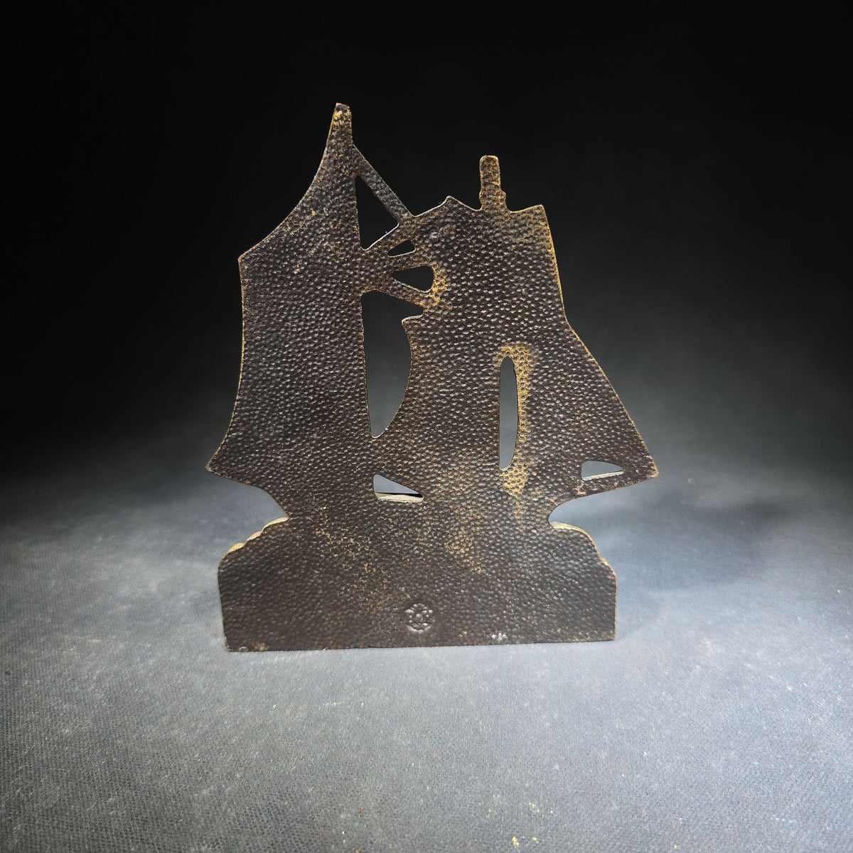 Pair of Antique Mismatched Cast Iron Bookends including a Standing Dog and a Sailing Ship, Manufactured by Bradley & Hubbard Mfg. Co., Meriden, Connecticut