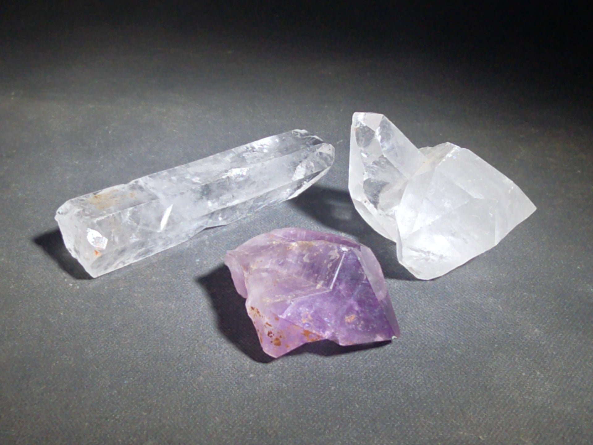 Trio of Quartz Crystal Specimens including Amethyst Point and Two Clear Quartz Points