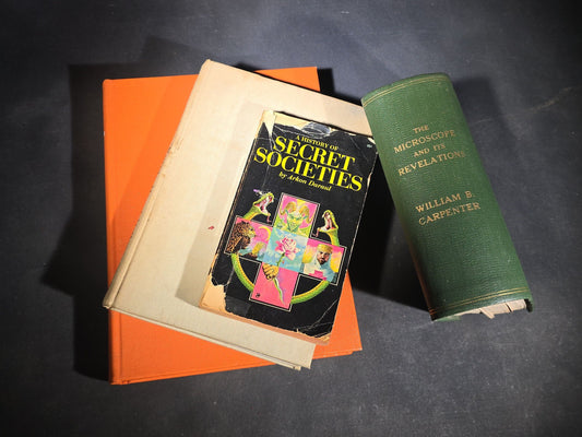 Grouping of Four Antique and Vintage Books including "The Microscope and Its Revelations" by William B. Carpenter, "They Called It Purple Heart Valley" by Margaret Bourke-White, "The Encyclopedia of UFOs," and "A History of Secret Societies"