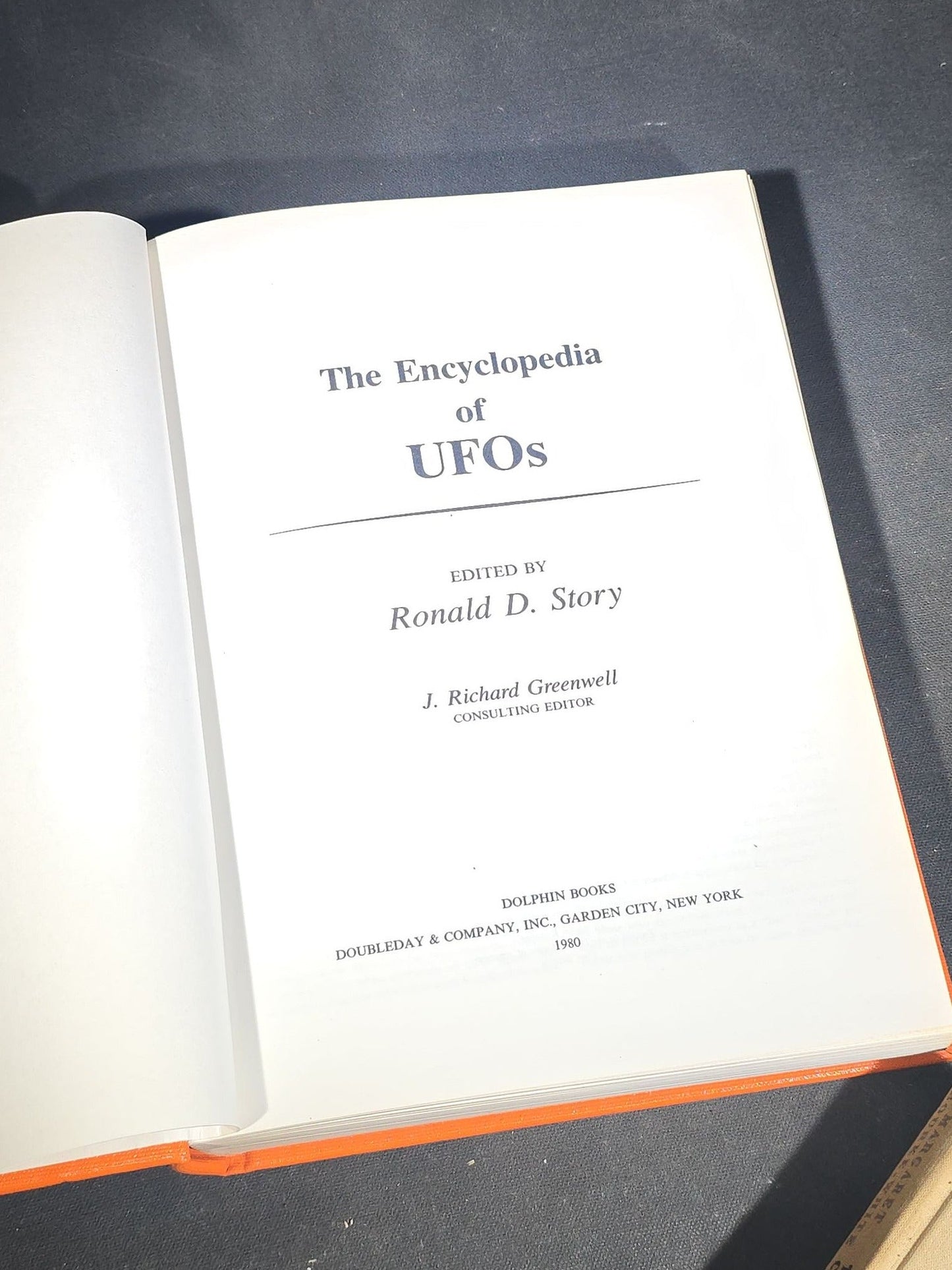 Grouping of Four Antique and Vintage Books including "The Microscope and Its Revelations" by William B. Carpenter, "They Called It Purple Heart Valley" by Margaret Bourke-White, "The Encyclopedia of UFOs," and "A History of Secret Societies"