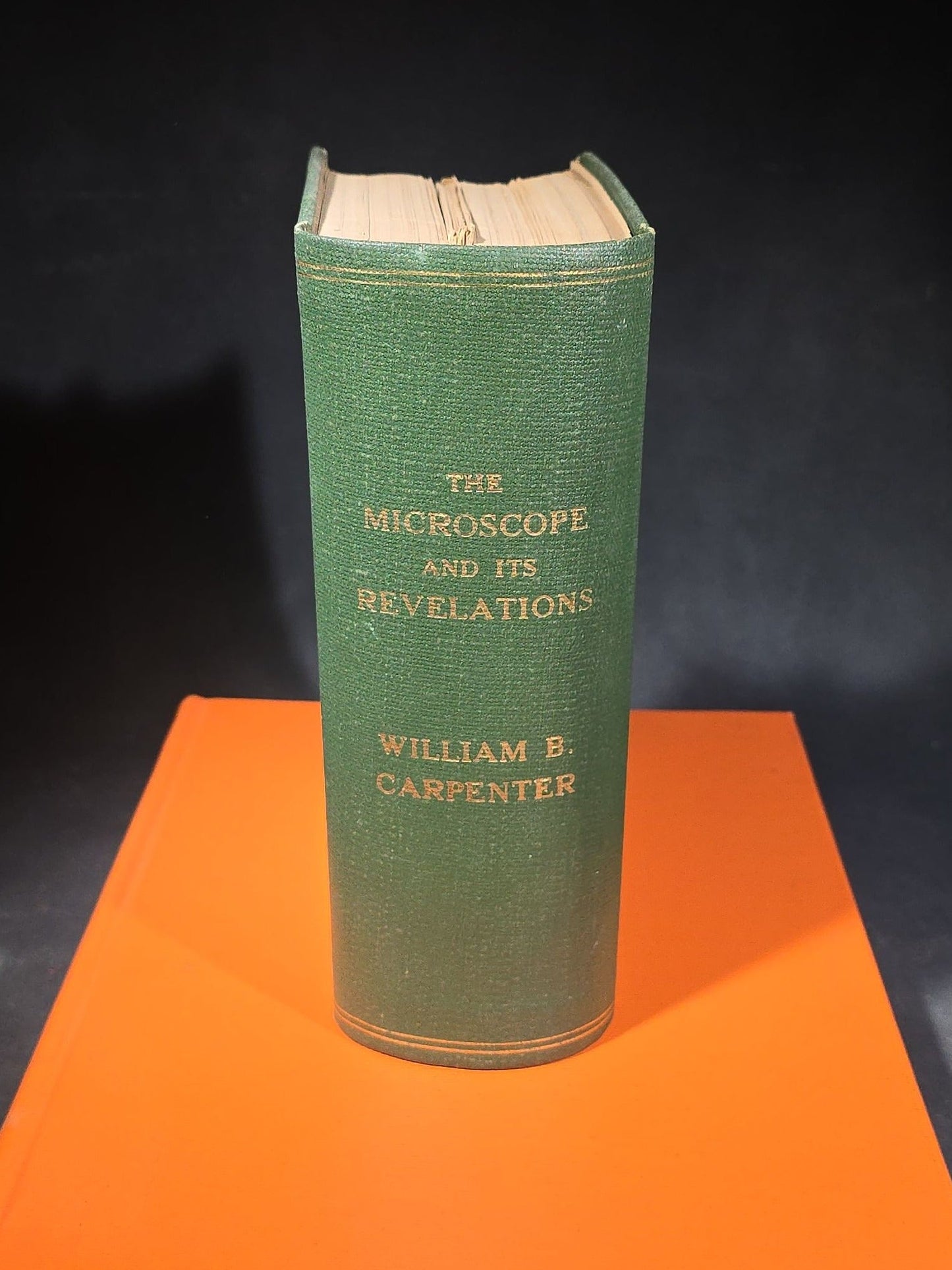 Grouping of Four Antique and Vintage Books including "The Microscope and Its Revelations" by William B. Carpenter, "They Called It Purple Heart Valley" by Margaret Bourke-White, "The Encyclopedia of UFOs," and "A History of Secret Societies"