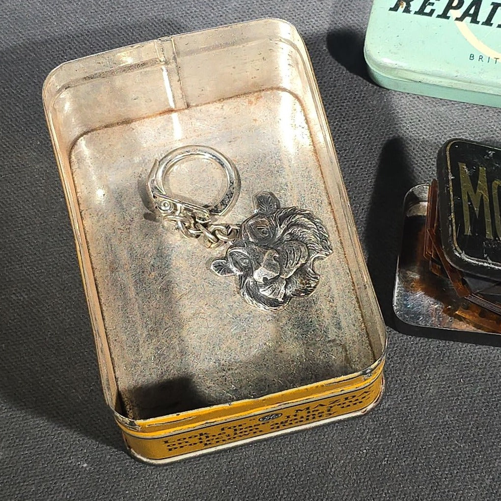 Grouping of Four Vintage Advertising Items including Edison Mazda Lamps Automotive Bulb Tin, Weldtite Self Vulcanising Cycle Repair Outfit Tin, Movielets Film Strip Tin, and Esso Tiger Keychain