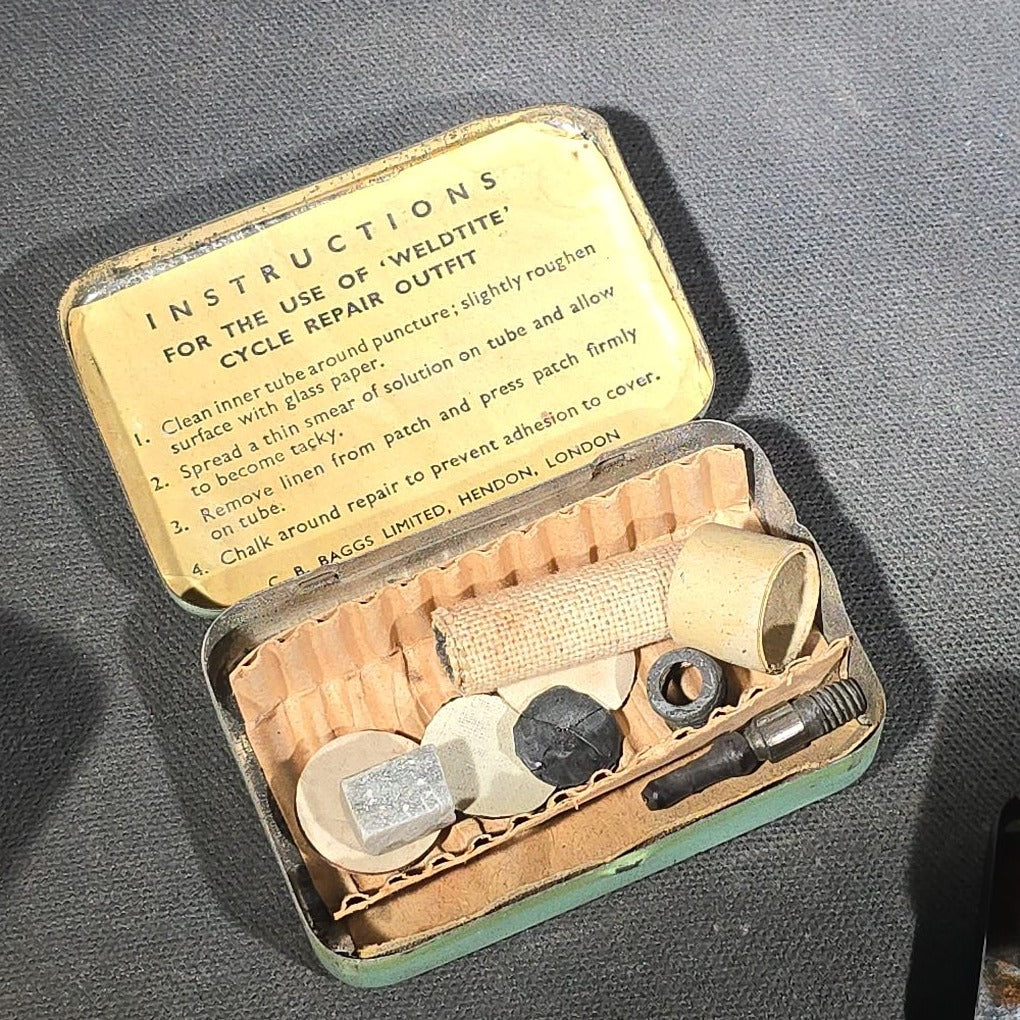 Grouping of Four Vintage Advertising Items including Edison Mazda Lamps Automotive Bulb Tin, Weldtite Self Vulcanising Cycle Repair Outfit Tin, Movielets Film Strip Tin, and Esso Tiger Keychain