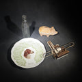 Lot 158 - Grouping of Four Antique and Vintage Items Including 1909 Advertising Calendar Plate from Grange Store, Amherst, Massachusetts, Orange Crush Embossed Soda Bottle, New York World's Fair Souvenir Tie Rack, and Composition Piggy Bank with Coins