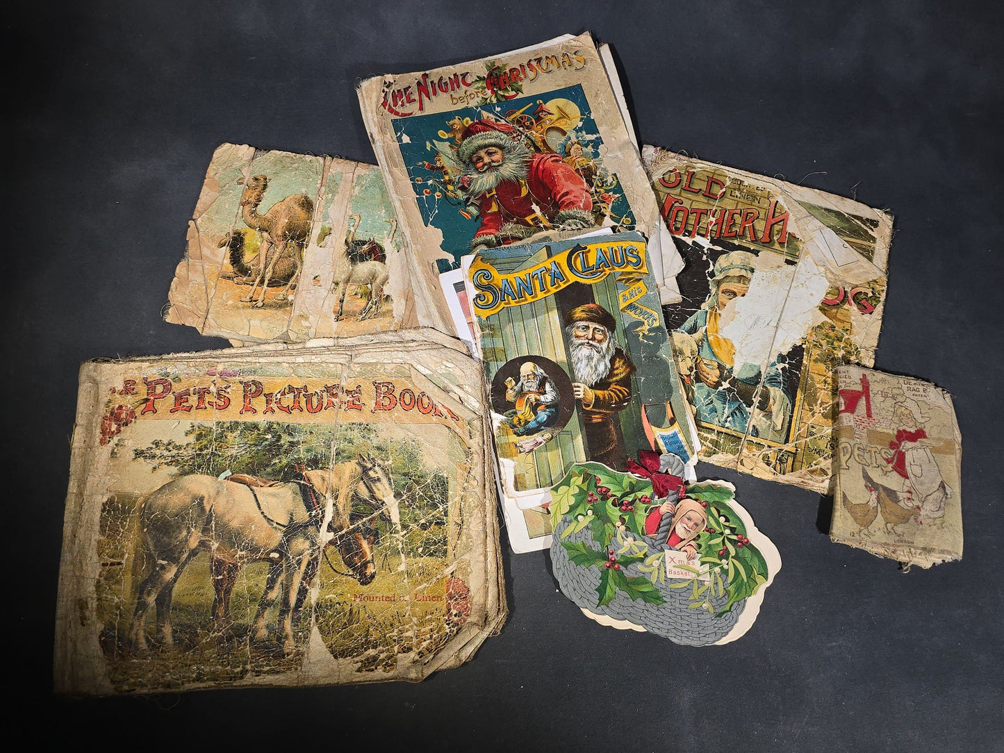 Grouping of Antique Craft Grade Illustrated Children's Books including "The Christmas Basket" by Mrs. Martha J. Lamb (1882), "Santa Claus & His Works" by McLoughlin Bros., "The Night Before Christmas," and Dean's Rag Book "Pets"