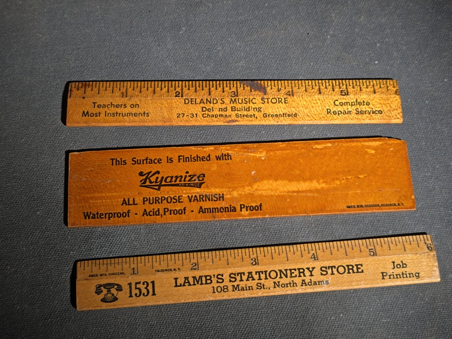 Grouping of 14 Antique and Vintage Smalls including 10 Wooden Advertising Rulers and Four Small Glass Bottles