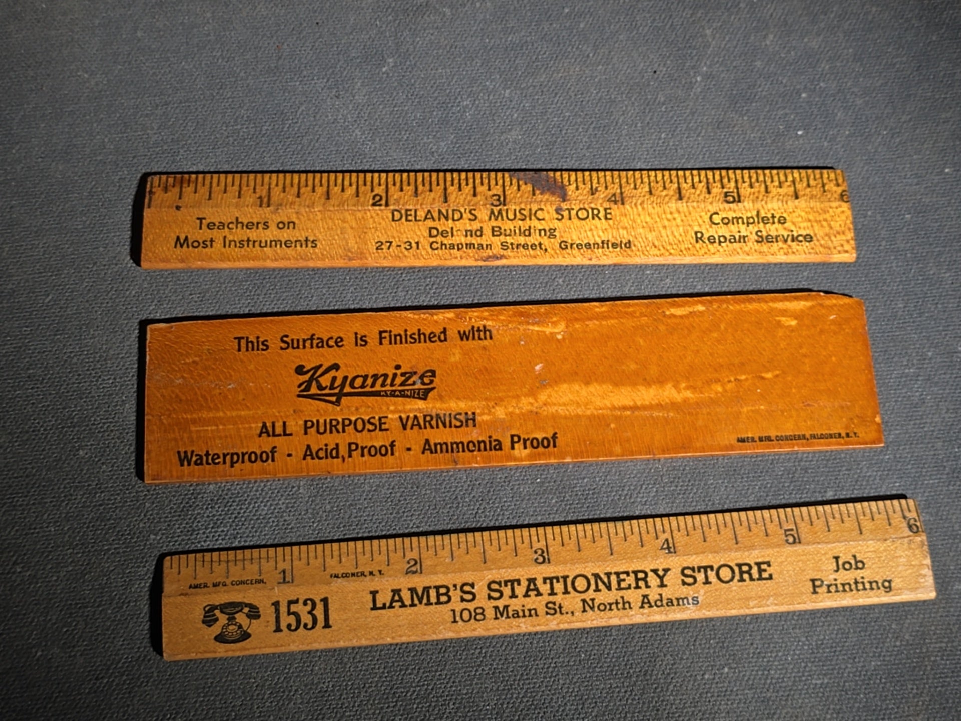 Grouping of 14 Antique and Vintage Smalls including 10 Wooden Advertising Rulers and Four Small Glass Bottles