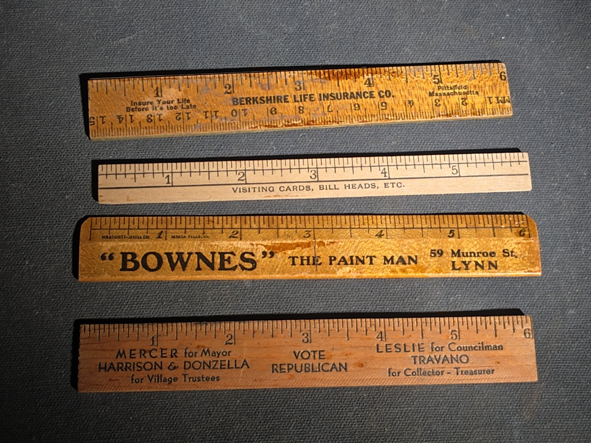 Grouping of 14 Antique and Vintage Smalls including 10 Wooden Advertising Rulers and Four Small Glass Bottles