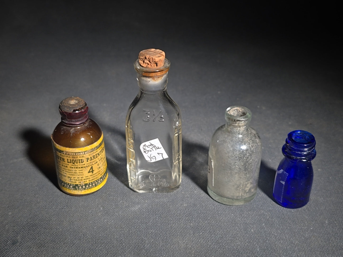 Grouping of 14 Antique and Vintage Smalls including 10 Wooden Advertising Rulers and Four Small Glass Bottles