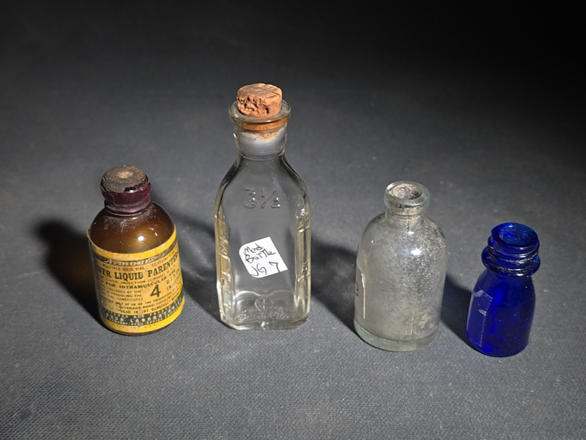 Grouping of 14 Antique and Vintage Smalls including 10 Wooden Advertising Rulers and Four Small Glass Bottles