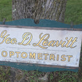 Lot 065 - Vintage Hand-Painted Double-Sided Wooden "Geo. D. Leavitt Optometrist" Trade Sign, 37" L x 22" H