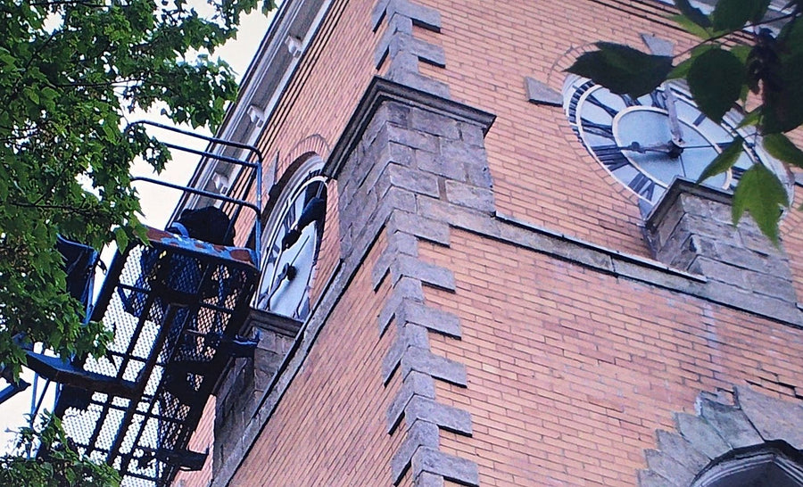 Removing an original clock face from a lift, 2008
