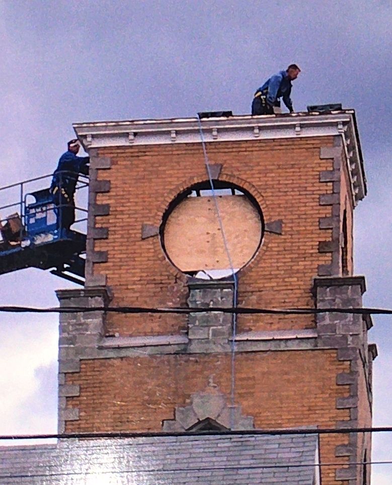 Both clock faces removed, openings left in the brick